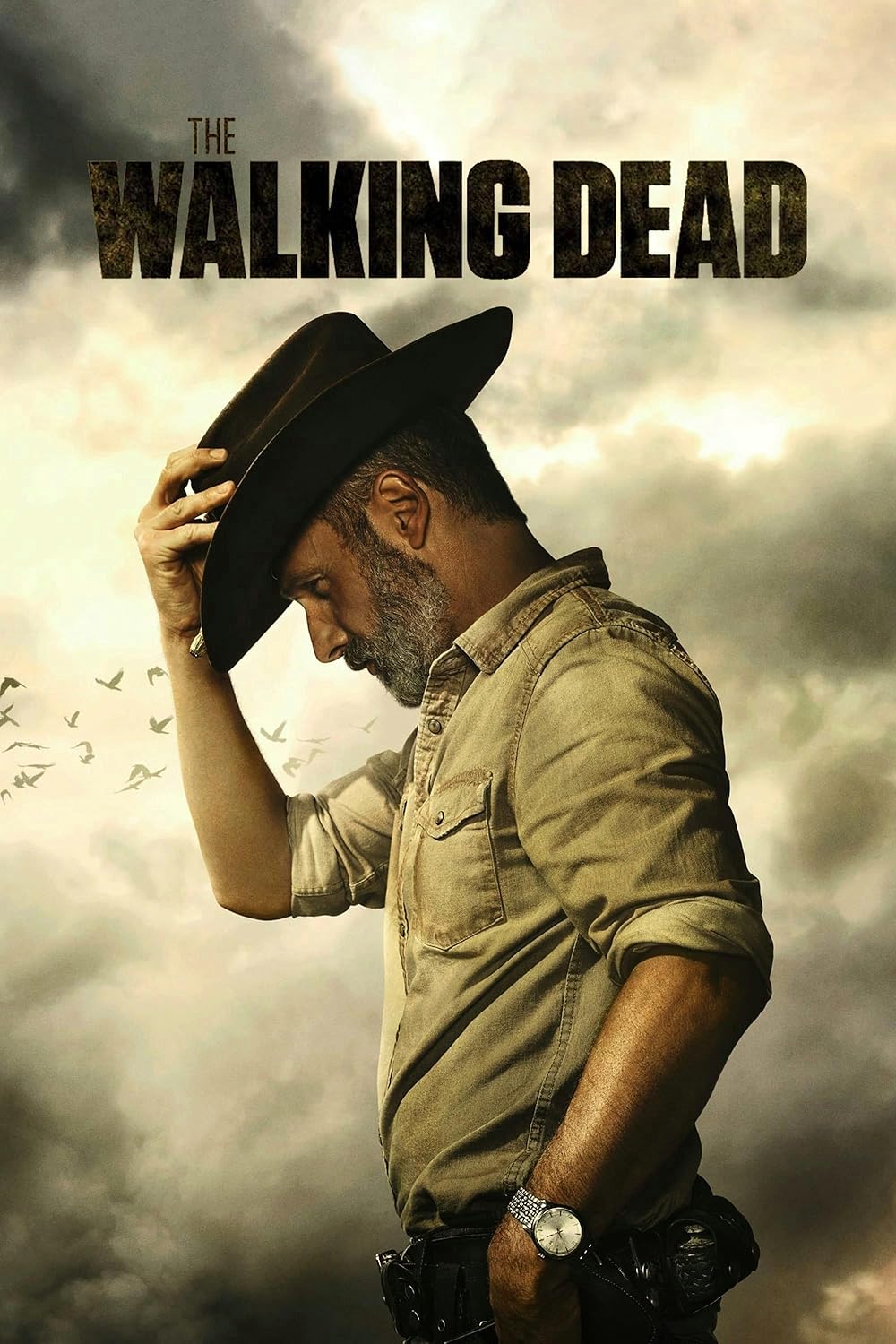 A man in a sheriff’s uniform and hat faces sideways, tilting his hat down. Dark, cloudy sky and birds flying in the background. Large text at the top reads The Walking Dead, featured on Ecuador IPTV.